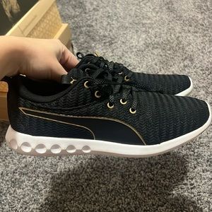 Black and gold women’s puma tennis shoes size 9